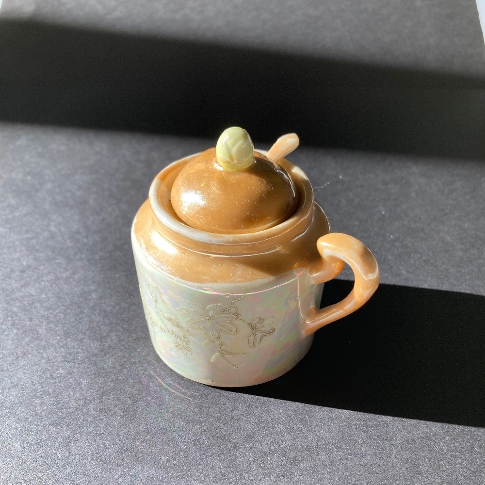 Japanese lustreware lidded jar with spoon.